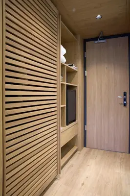 a room with a sliding door and a television at Golden Age Athens Hotel in Athens
