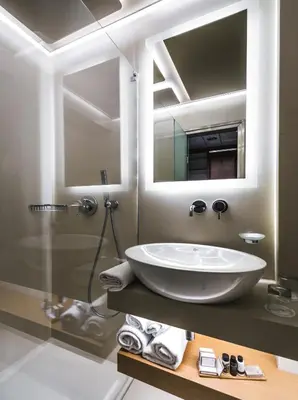 a bathroom with a large sink and a mirror at Golden Age Athens Hotel in Athens