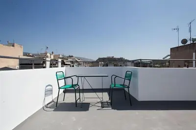 two chairs and a table on a roof at A comfortable small studio nearby Acropolis 2 in Athens
