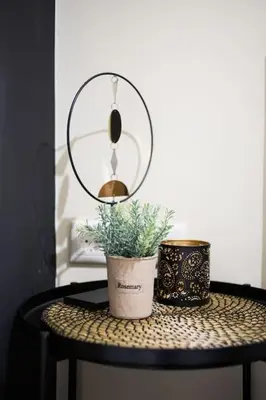 a table with a potted plant and a mirror at A comfortable small studio nearby Acropolis 3 in Athens