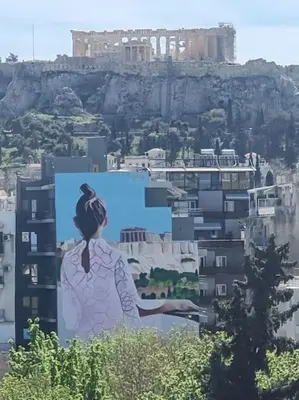 a painting of a woman on the side of a building at A comfortable small studio nearby Acropolis 5 in Athens