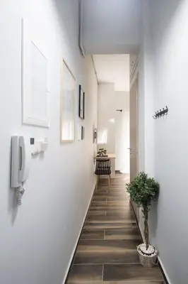 a hallway with a phone and a potted plant at A comfortable small studio nearby Acropolis 5 in Athens