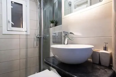 a bathroom with a white bowl sink on a counter at A comfortable small studio nearby Acropolis 5 in Athens
