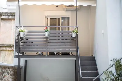 a stair case with potted plants on it at A comfortable small studio nearby Acropolis 5 in Athens