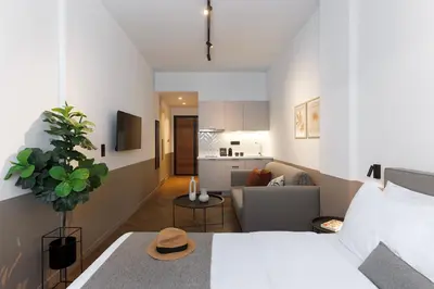 a bedroom with a bed and a living room at ERMASS Athens in Athens