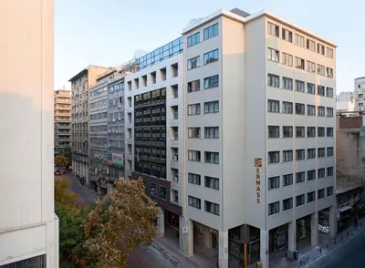 an aerial view of a tall white building at ERMASS Athens in Athens