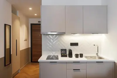 a kitchen with white cabinets and a sink at ERMASS Athens in Athens