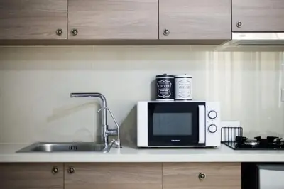a kitchen counter with a microwave and a sink at A comfortable small studio nearby Acropolis 201 in Athens