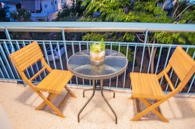 two chairs and a table on a balcony at Διαμέρισμα 2 ΣΤΗΝ ΑΓΙΑ ΜΑΡΙΝΑ in Agia Marina Aegina