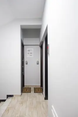 a hallway with white walls and a wooden floor at A comfortable small studio nearby Acropolis 202 in Athens