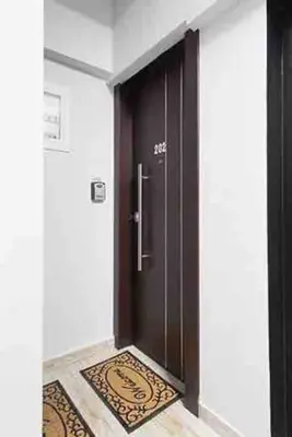 a black door with a rug in front of it at A comfortable small studio nearby Acropolis 202 in Athens