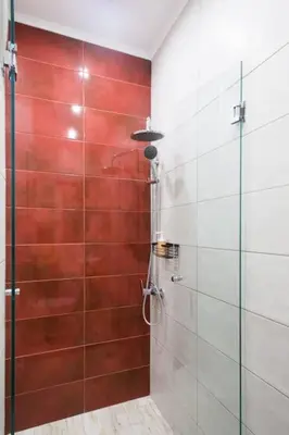 a shower with a glass door in a bathroom at A comfortable small studio nearby Acropolis 202 in Athens