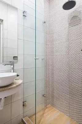 a bathroom with a glass shower with a sink at A comfortable small studio nearby Acropolis 203 in Athens