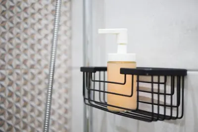 a soap dispenser hanging on a bathroom wall at A comfortable small studio nearby Acropolis 203 in Athens