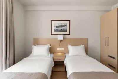 two beds sitting next to each other in a room at Gallery Central Piraeus Port in Piraeus