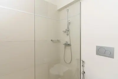a shower with a glass door in a bathroom at Gallery Central Piraeus Port in Piraeus
