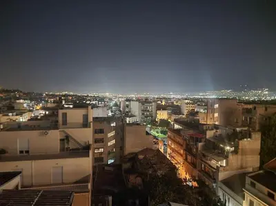 a view of a city at night with lights at Small studio under Acropolis B! in Athens