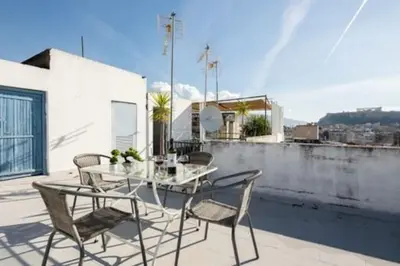 a patio with a table and chairs on a balcony at Small studio under Acropolis B! in Athens