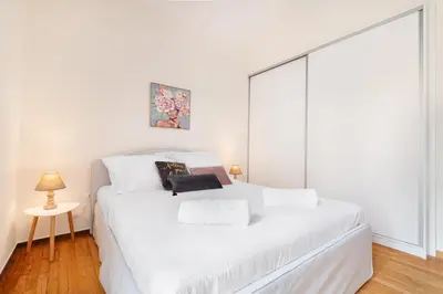 a white bed in a room with a large window at Edem Beach Apartment by Alimos Marina - Athenian Homes in Athens
