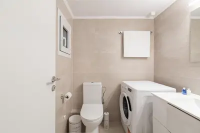 a bathroom with a washing machine and a sink at Edem Beach Apartment by Alimos Marina - Athenian Homes in Athens