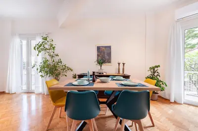 a dining room with a wooden table and chairs at Edem Beach Apartment by Alimos Marina - Athenian Homes in Athens