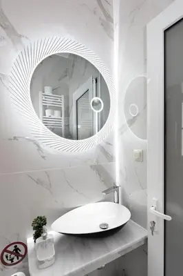 a white bathroom with a sink and a mirror at Small studio under Acropolis A! in Athens