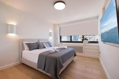 a bedroom with a bed and a large window at Top Notch Stay In Kolonaki in Athens