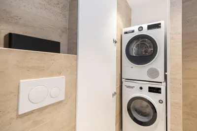 a washing machine and a washer and dryer in a bathroom at Top Notch Stay In Kolonaki in Athens