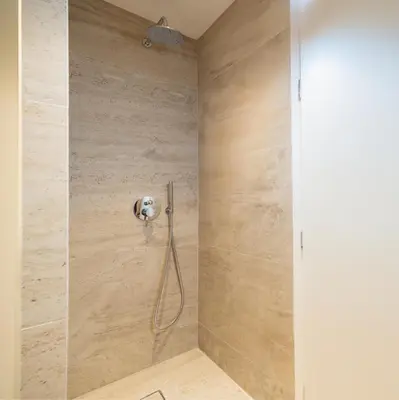 a shower with a shower head in a bathroom at Top Notch Stay In Kolonaki in Athens