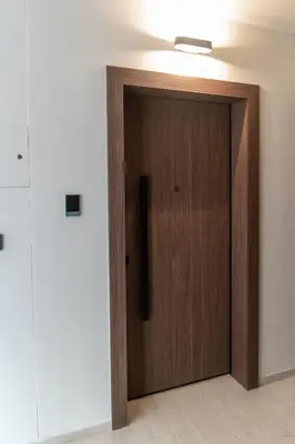 a wooden door in a room with a white wall at Top Notch Stay In Kolonaki in Athens