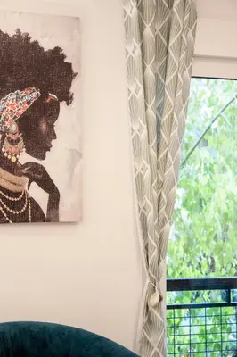 a painting hanging on a wall next to a window at Afroditi in Athens