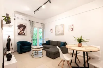 a living room with a couch and a table at Afroditi in Athens