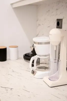 a kitchen counter with a coffee maker on it at Afroditi in Athens