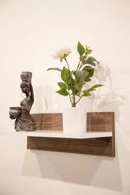 a statue of a woman sitting on a shelf with a plant at Afroditi in Athens