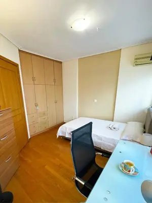 a room with a bed and a desk with a chair at DSL - Downtown Skyline Loft in Athens