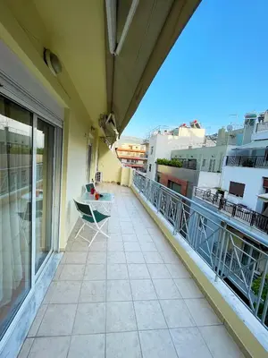 a balcony with a table and chairs on a building at DSL - Downtown Skyline Loft in Athens