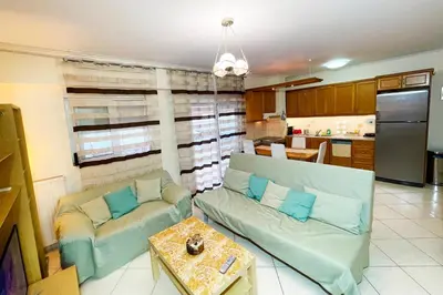 a living room with a couch and a table at DSL - Downtown Skyline Loft in Athens