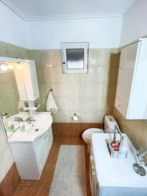 a bathroom with a sink and a toilet and a mirror at DSL - Downtown Skyline Loft in Athens