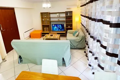 a living room with a couch and a tv at DSL - Downtown Skyline Loft in Athens