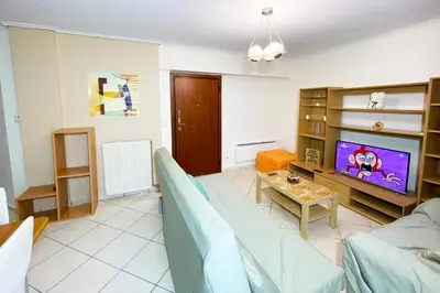 a living room with a couch and a tv at DSL - Downtown Skyline Loft in Athens