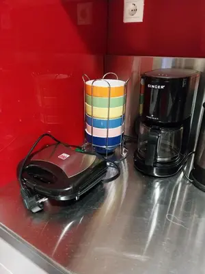 a toaster and coffee pot sitting on a kitchen counter at Lucie's Apartment in Athens