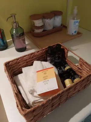 a basket sitting on a counter with bottles of soap at Lucie's Apartment in Athens