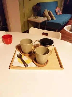 a tray with cups and spoons on a table at Lucie's Apartment in Athens