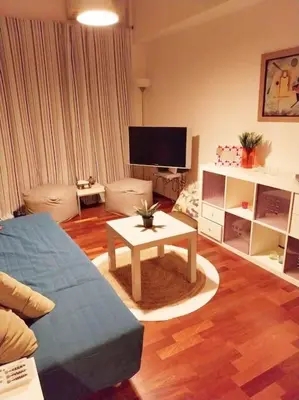 a living room with a couch and a table at Lucie's Apartment in Athens