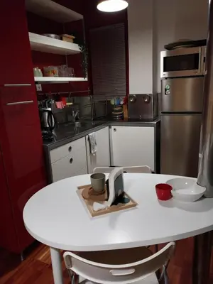 a kitchen with a white table with two cups on it at Lucie's Apartment in Athens