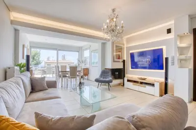 a living room with a couch and a glass table at Saronida Hills private Pool in Saronida