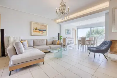 a living room with a couch and a table at Saronida Hills private Pool in Saronida