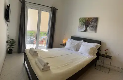 a bedroom with a large bed with towels on it at Sirius Escape in Spáta