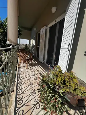 a balcony with a bench and plants on a house at Sirius Escape in Spáta