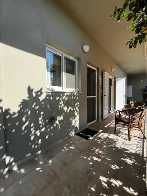 a patio with a bench and a window at Sirius Escape in Spáta